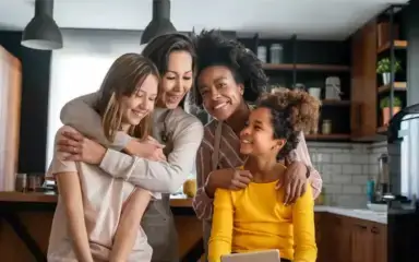 Family in their kitchen smiling