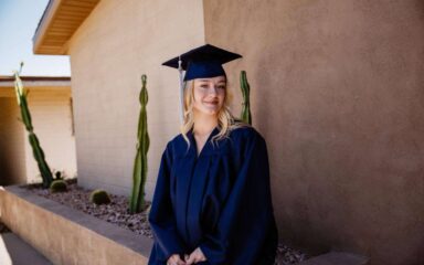 Brianna, a 16-year-old graduate of Arizona Virtual Academy, smiles in her cap and gown.